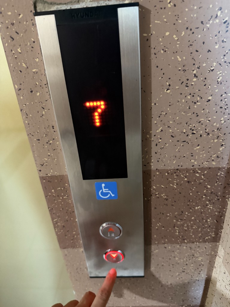 Hand pressing the elevator call button