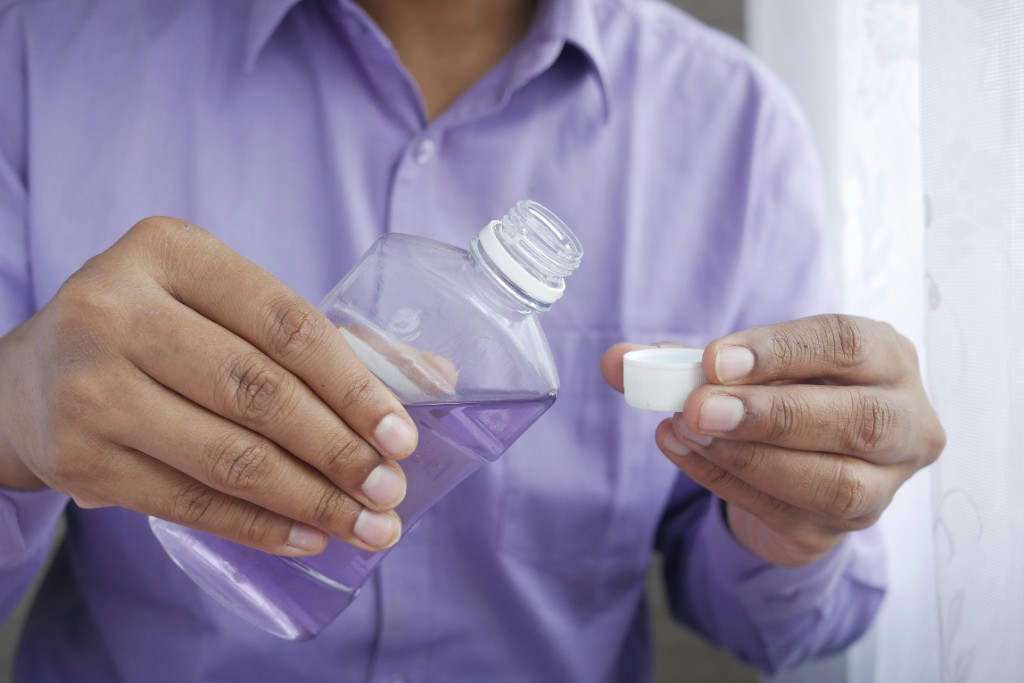 Pouring mouthwash — use only as directed and do not hold it in your mouth longer than the label says