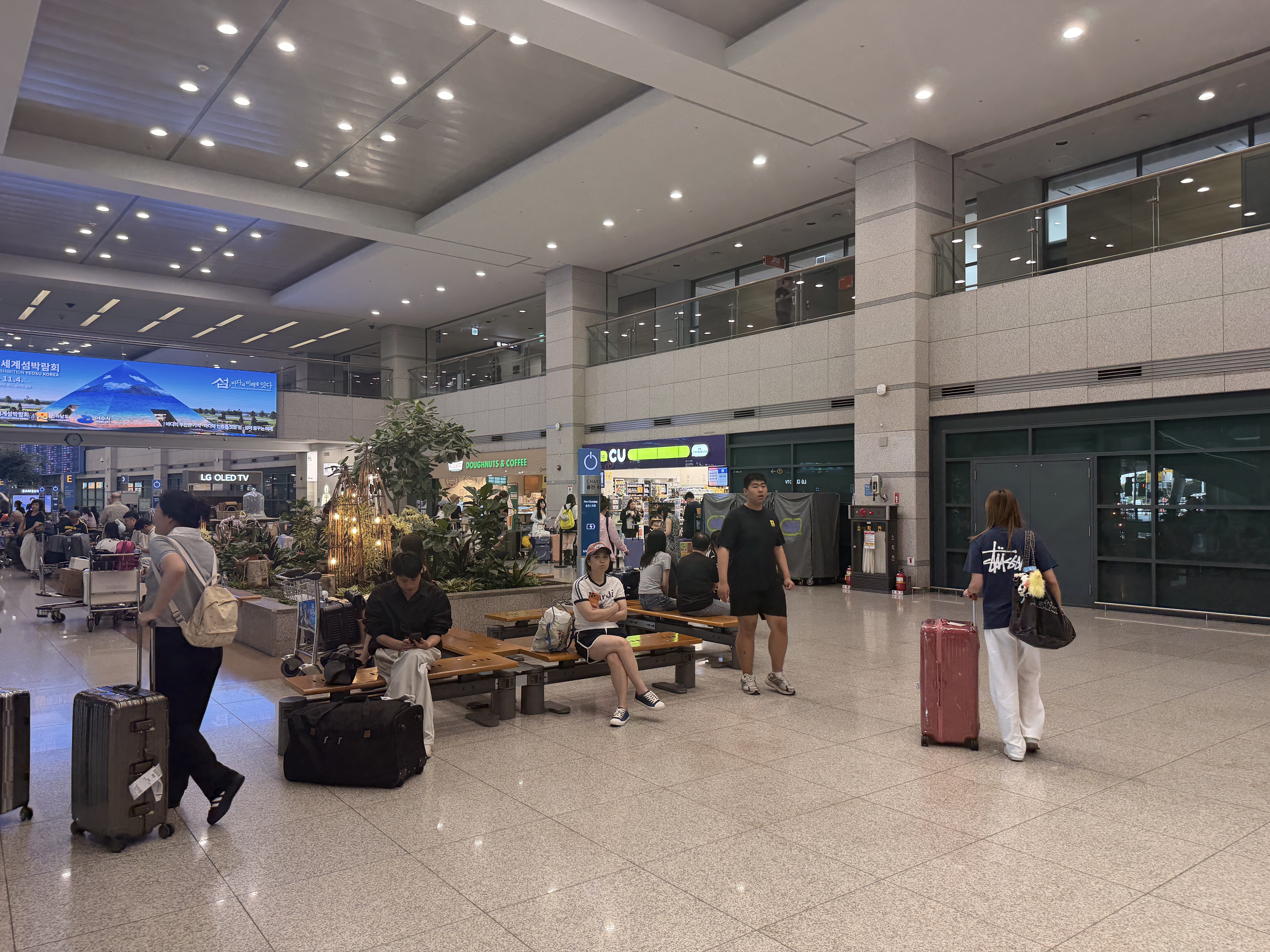Waiting hall benches with CU and Dunkin in the background at Incheon Airport