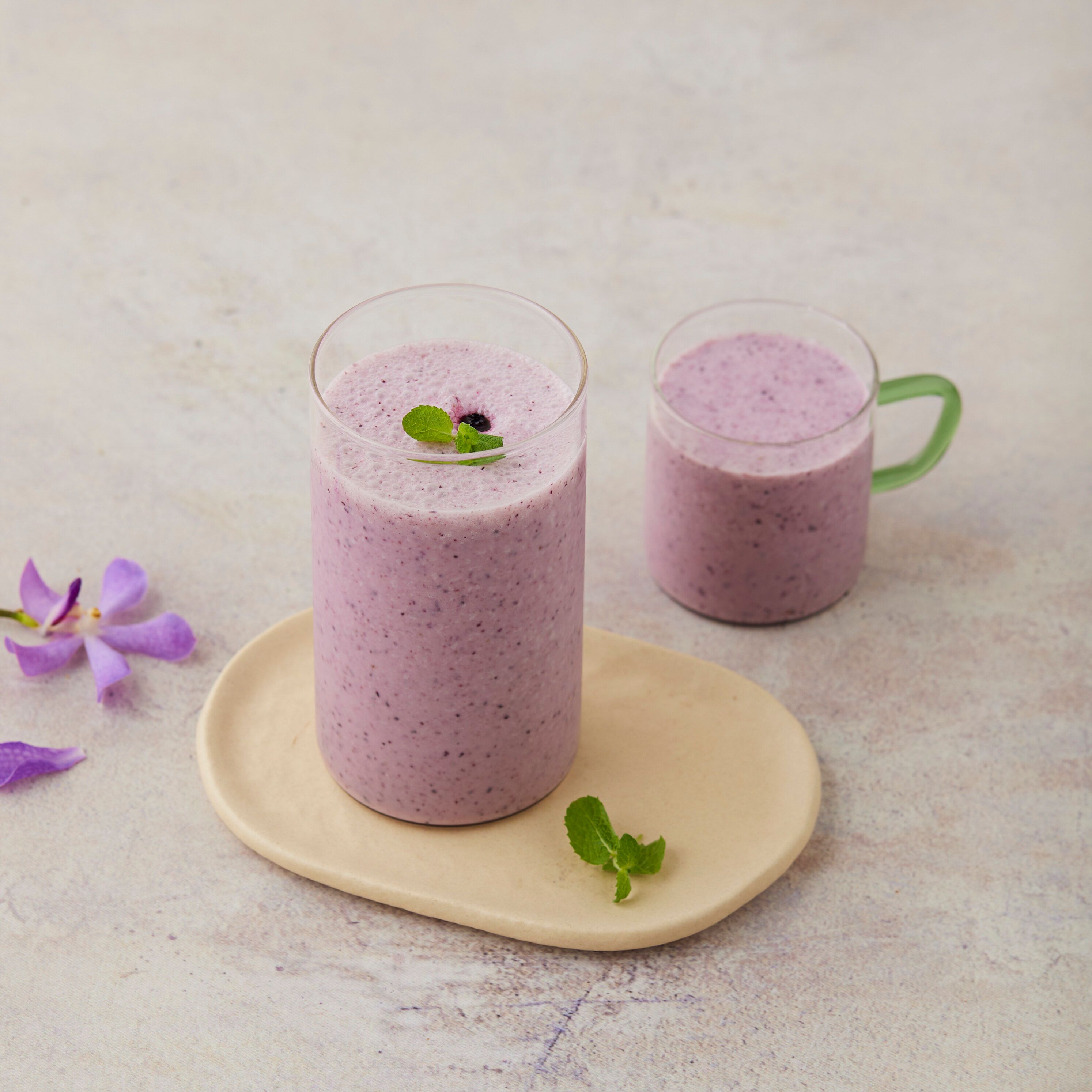 Blended green vegetable smoothie in a glass