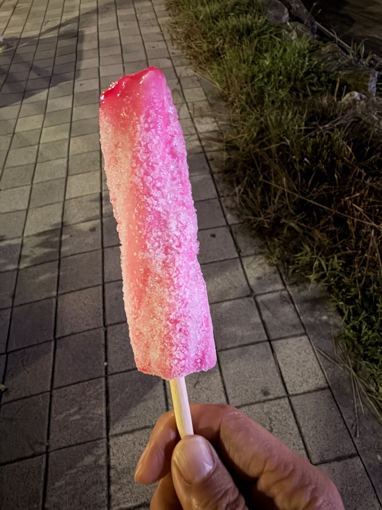 Pink Screw Bar held outdoors at night after a bite