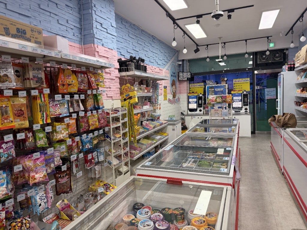 Interior of an unmanned ice cream shop with freezers and self-checkout kiosks
