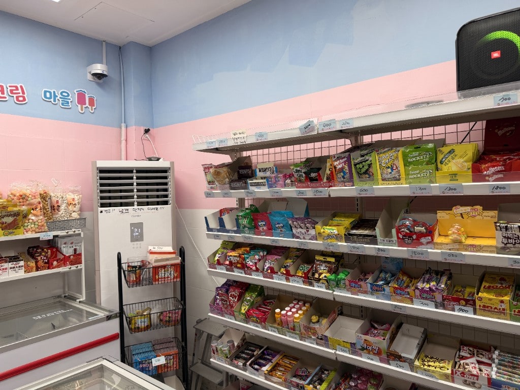Snack wall with price tags and pastel pink-blue striping